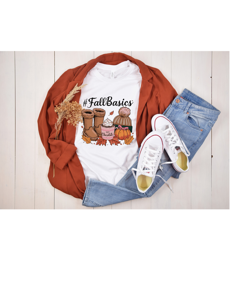 A stylish flat lay featuring a "#FallBasics" t-shirt, brown boots, jeans, a rust blazer, and white sneakers